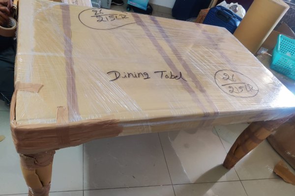 Dining table wrapped and labelled for shifting in Bangalore