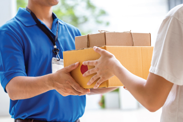 Packed carton being handed over at delivery