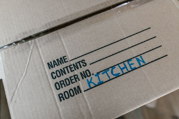 Moving cartons labelled room by room for house shifting